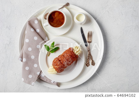 Czech trdelnik with cream and coffee, top view 64694102