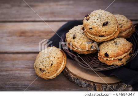 Homemade oatmeal sandwich cookies 64694347