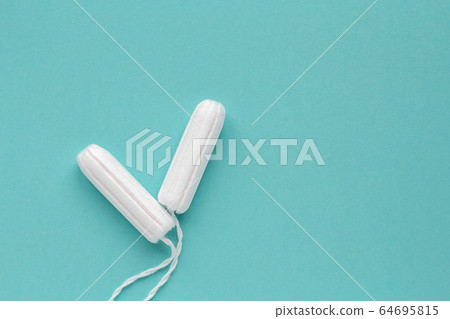 Cotton tampons on medical background. Copy space. Cotton tampons on medical background. Copy space. 64695815