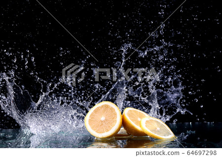 Sliced lemon in the water on black background Sliced lemon in the water on black background 64697298