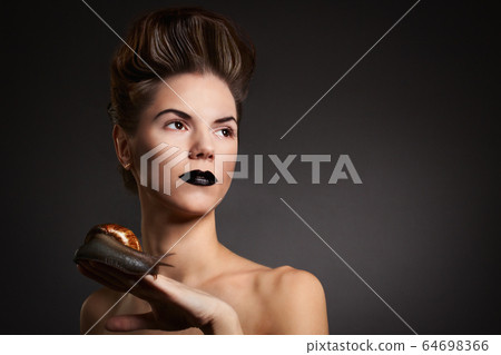 Sexy woman with snail with black eyes and lips. 64698366