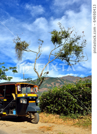 Rickshaw standing on village road in India Rickshaw standing on village road in India 64698413