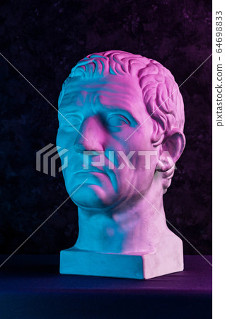 Statue of Guy Julius Caesar Octavian Augustus. Creative concept colorful neon image with ancient roman sculpture Guy Julius Caesar Octavian Augustus head. Cyberpunk, vaporwave and surreal art style. 64698833