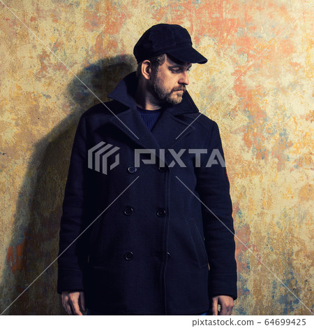 attractive young bearded man in a pea coat attractive young bearded man in a pea coat 64699425