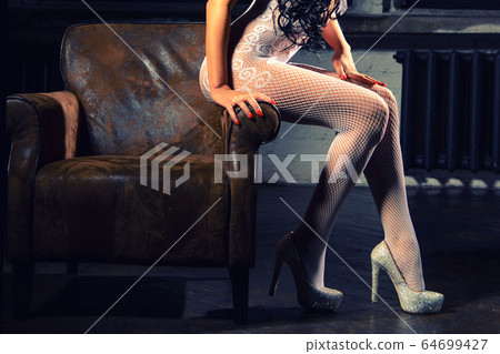 Beautiful woman legs in white stockings on high 64699427