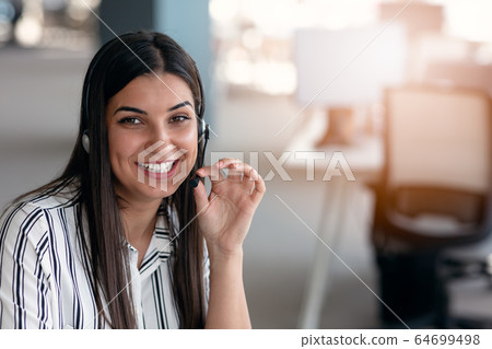 Happy smiling woman working in call center 64699498