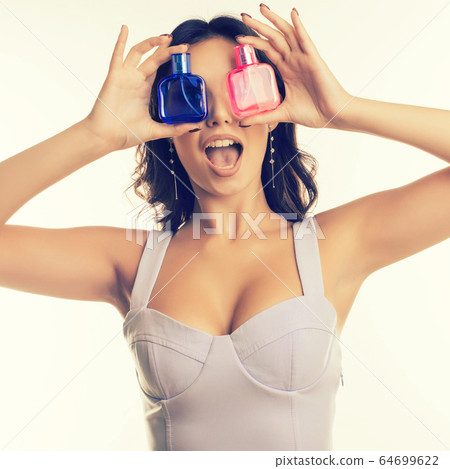 surprised girl closes her eyes with perfume 64699622