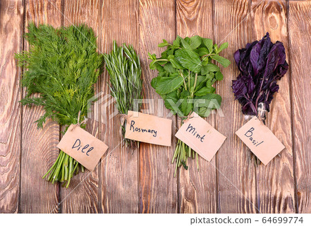 Fresh herbs hanging over wooden background 64699774
