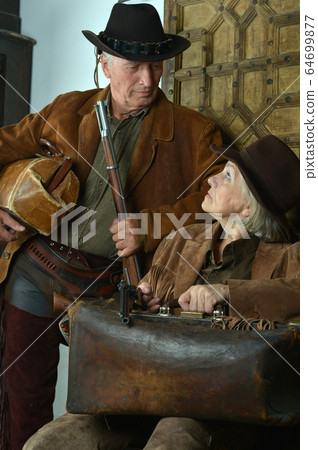 Happy gunslingers in western garment on black 64699877