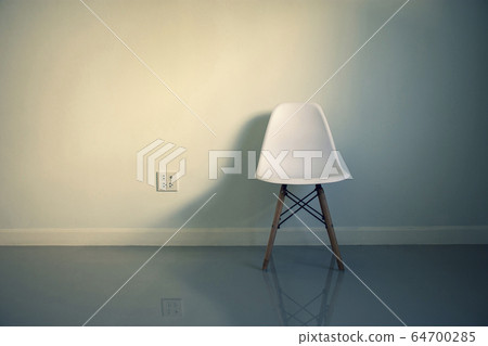 White chair with shadow and plug socket in a room. White chair with shadow and plug socket in a room. 64700285