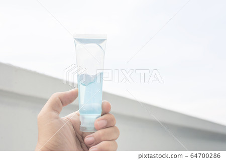 Alcohol hand gel sanitizer in a hand. Alcohol hand gel sanitizer in a hand. 64700286