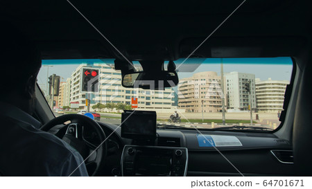 View from the cab of a car taxi to the streets of Dubai. View from the cab of a car taxi to the streets of Dubai. 64701671