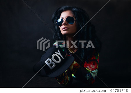 Sexy brunette in a black cap and glasses. Swag Sexy brunette in a black cap and glasses. Swag 64701748