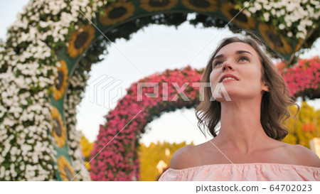 A girl walks through a fabulous park in Dubai. A girl walks through a fabulous park in Dubai. 64702023