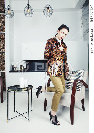 pretty stylish woman in fashion dress with leopard print in luxury house interior, lifestyle people concept 64702184