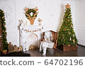 Interior decorated with Christmas decor. White walls with stucco and artificial stone.  64702196