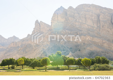 Mountains near the hot thermal springs in the United Arab Emirates near Ain Al. Mountains near the hot thermal springs in the United Arab Emirates near Ain Al. 64702363