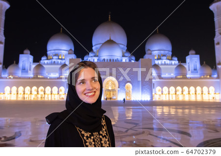 Portrait of a girl in hijab in a mosque. 64702379