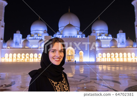 Portrait of a girl in hijab in a mosque. 64702381