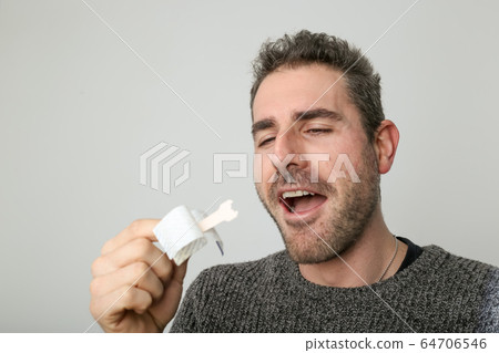 Man observing a new nasal strip 64706546