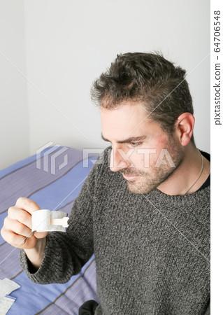 Man observing a new nasal strip 64706548