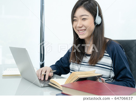 Student sitting in living room and learning online 64706637