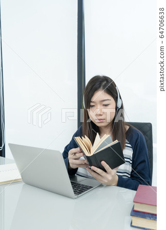 Student sitting in living room and learning online 64706638