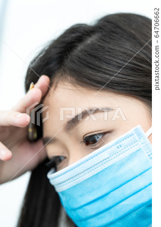 Close up woman with headache wearing mask for Close up woman with headache wearing mask for 64706662