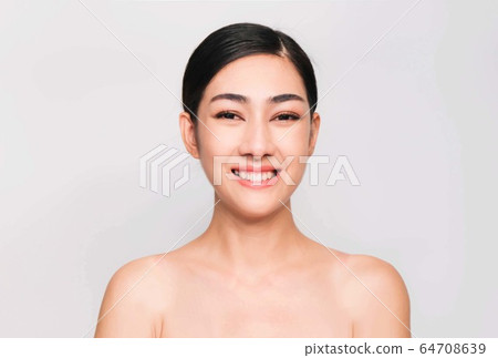 young beautiful asian woman with clean and bright skin, Cosmetic Beauty Concept,hands touch on the cheek, smiling and friendly face isolated on grey background young beautiful asian woman with clean and bright skin, Cosmetic Beauty Concept,hands touch on the cheek, smiling and friendly face isolated on grey background 64708639
