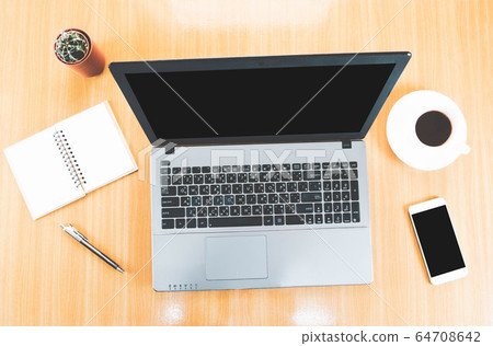 Selective focus,Top view of wooden desktop with laptop, blank mobile phone, pen, coffee cup,cactus and notebook Selective focus,Top view of wooden desktop with laptop, blank mobile phone, pen, coffee cup,cactus and notebook 64708642
