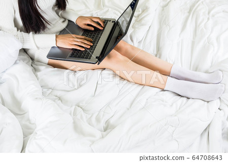 Selective focus a body part of young asian woman wear white knitwear dress on bed,work online lifestyle relax at home ,white blanket copy space Selective focus a body part of young asian woman wear white knitwear dress on bed,work online lifestyle relax at home ,white blanket copy space 64708643