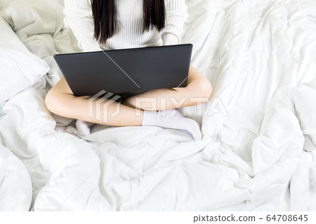 Selective focus a body part of young asian woman wear white knitwear dress on bed,work online lifestyle relax at home ,white blanket copy space Selective focus a body part of young asian woman wear white knitwear dress on bed,work online lifestyle relax at home ,white blanket copy space 64708645