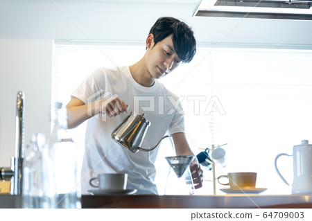 Young men making coffee Young men making coffee 64709003