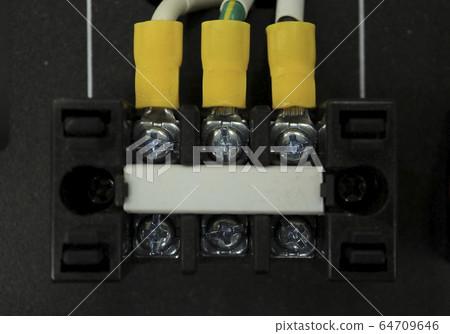 Panel with electrical wires and screws visible 64709646