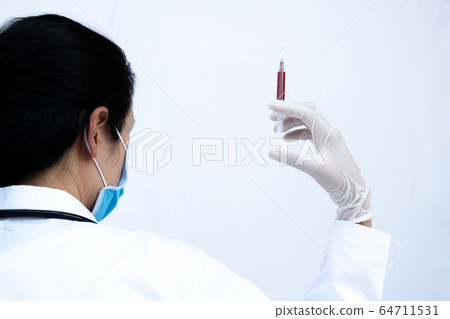 The picture of doctor's hand holding syringe The picture of doctor's hand holding syringe 64711531