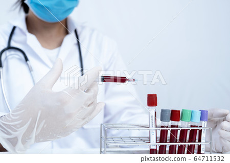 The picture of blood tube and doctor's hand The picture of blood tube and doctor's hand 64711532