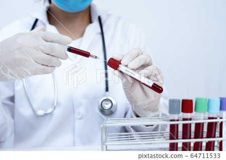 The picture of blood tube and doctor's hand The picture of blood tube and doctor's hand 64711533