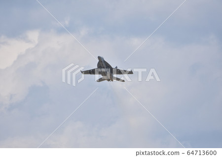 FA-18 fighter attack aircraft of the US Navy flying in the sea of clouds FA-18 fighter attack aircraft of the US Navy flying in the sea of clouds 64713600