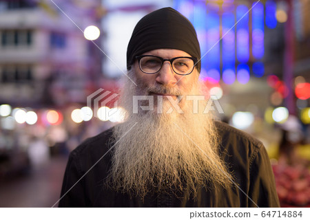 Face of mature bearded tourist man with eyeglasses in Chinatown at night Face of mature bearded tourist man with eyeglasses in Chinatown at night 64714884