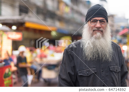 Mature bearded tourist man wearing eyeglasses in Chinatown 64714892