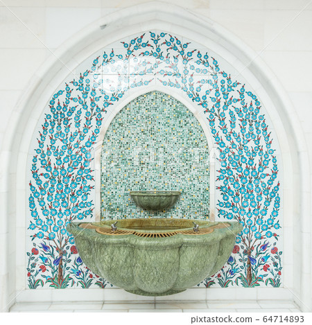 Tiled ornament drinking water fountains on forecourt of islamic mosque 64714893