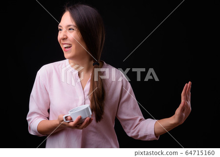 Young multi ethnic beautiful businesswoman against black background 64715160