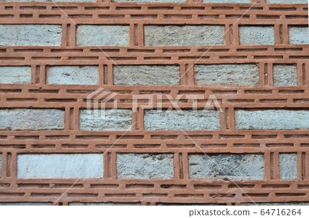 Sturdy beige and red cut stone wall, seamless Sturdy beige and red cut stone wall, seamless 64716264