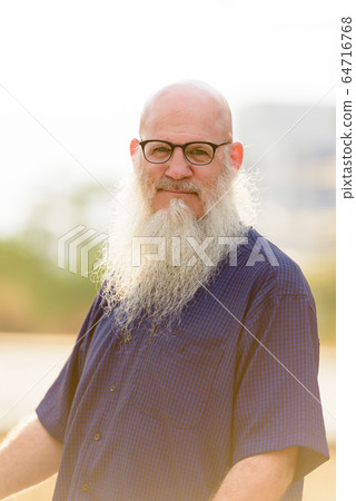 Portrait of mature bald bearded man with eyeglasses Portrait of mature bald bearded man with eyeglasses 64716768