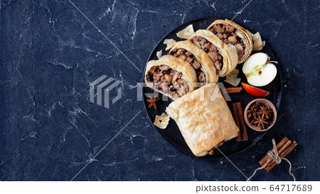 Apple strudel on a dark background, copy space Apple strudel on a dark background, copy space 64717689