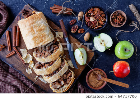 Traditional apple strudel with raisins, top view Traditional apple strudel with raisins, top view 64717700