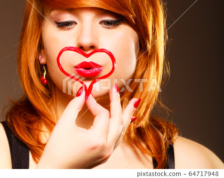 Woman creating heart symbol. 64717948