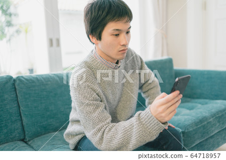 Smartphone male student Smartphone male student 64718957
