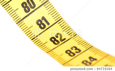 Close-up of a yellow measuring tape isolated on 64719164