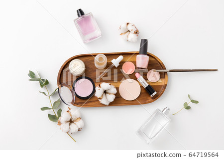 makeup, perfume and cosmetics on wooden tray makeup, perfume and cosmetics on wooden tray 64719564